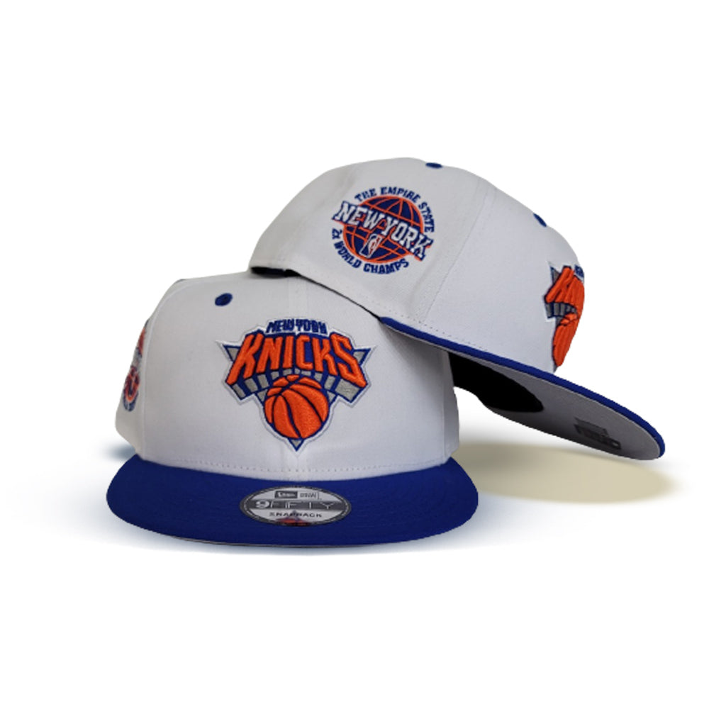 https://exclusivefitted.com/cdn/shop/products/White-New-York-Knicks-Royal-Blue-Visor-Gray-Bottom-2X-World-Champs-New-Era-9Fifty-Snapback---1.jpg?v=1655395611